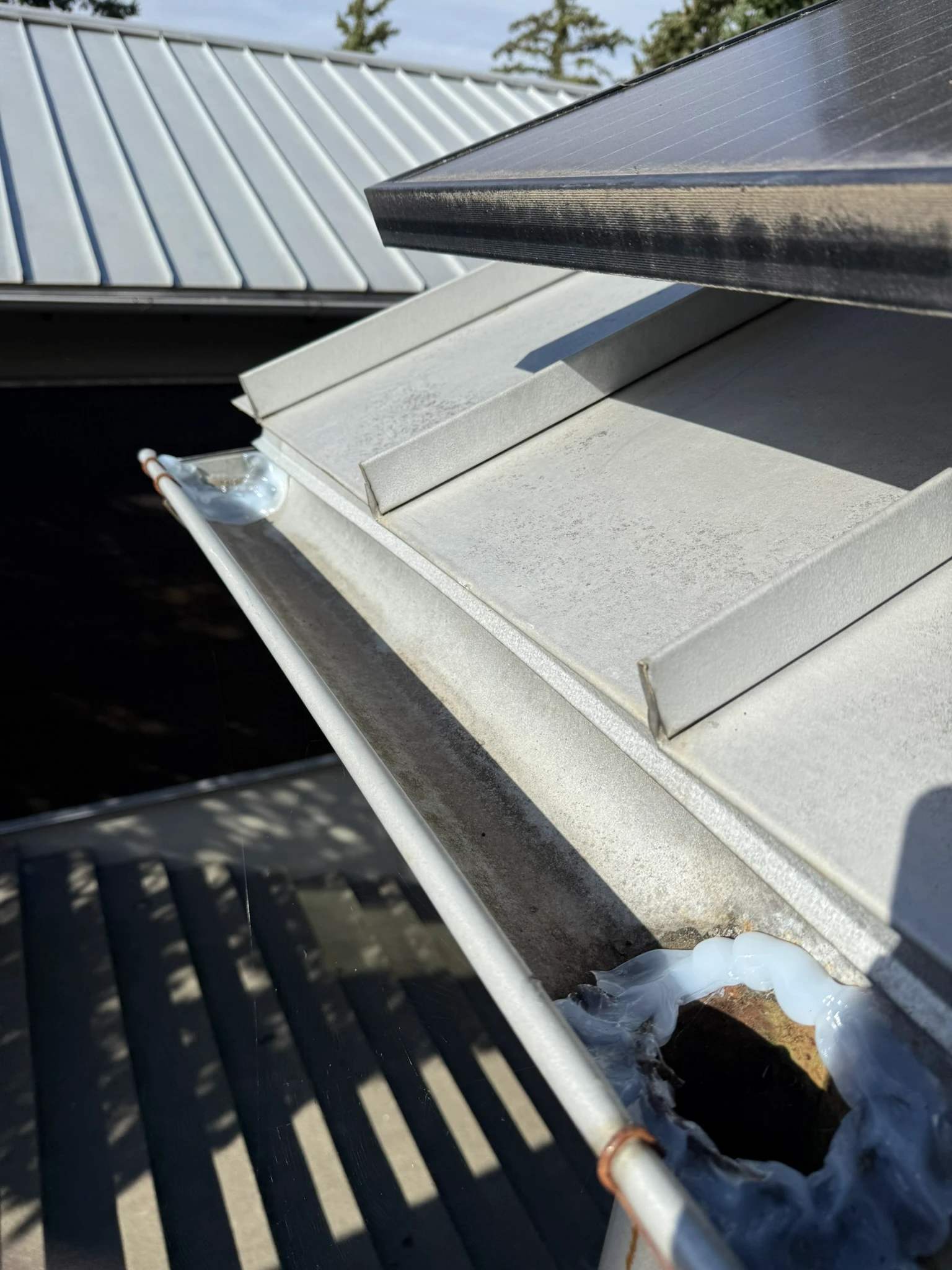 Freshly sealed half-round gutters on a Seattle home