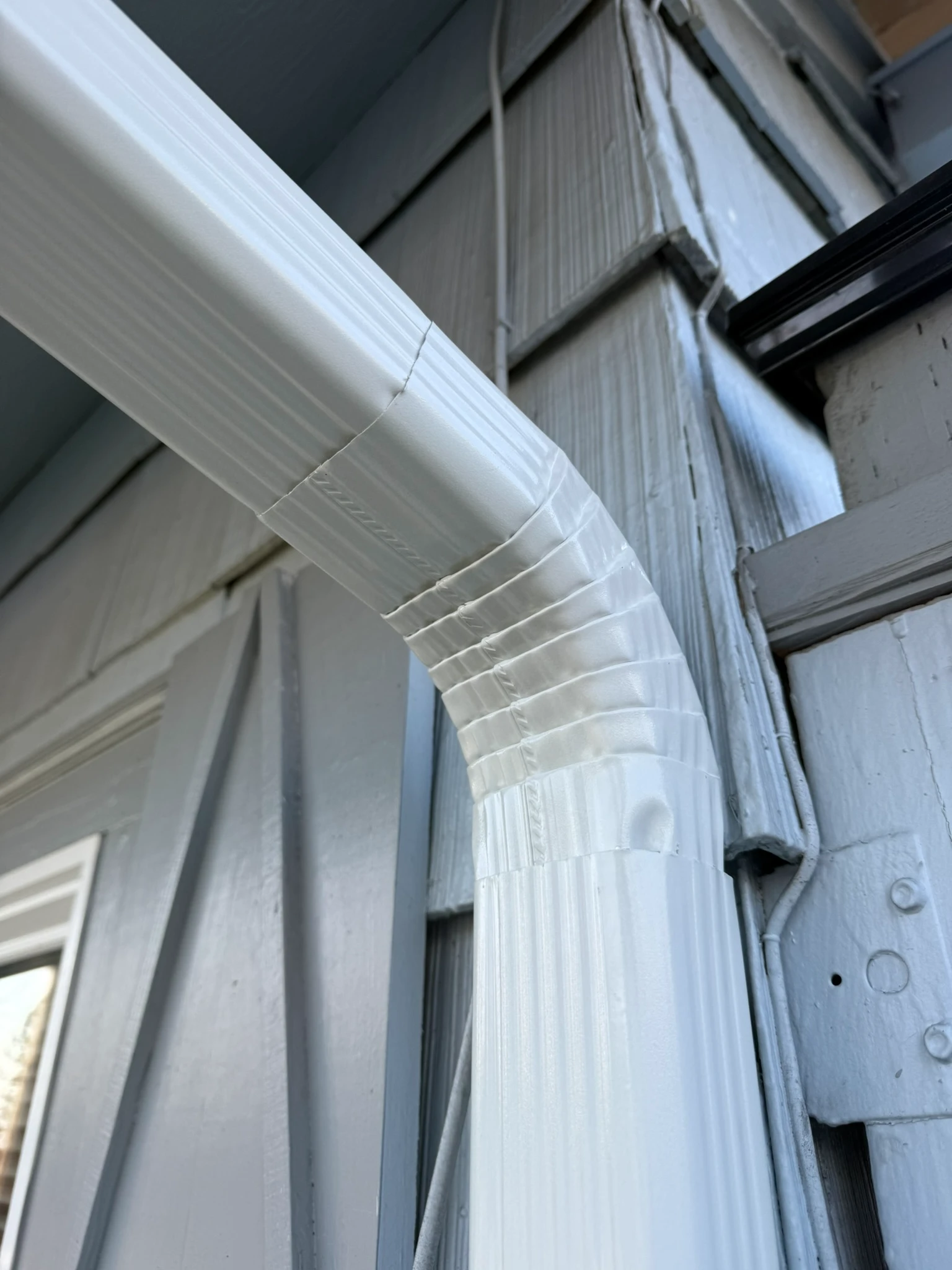 Education Hill – February 2026: Exterior vent termination detail installed during fan reroute project.