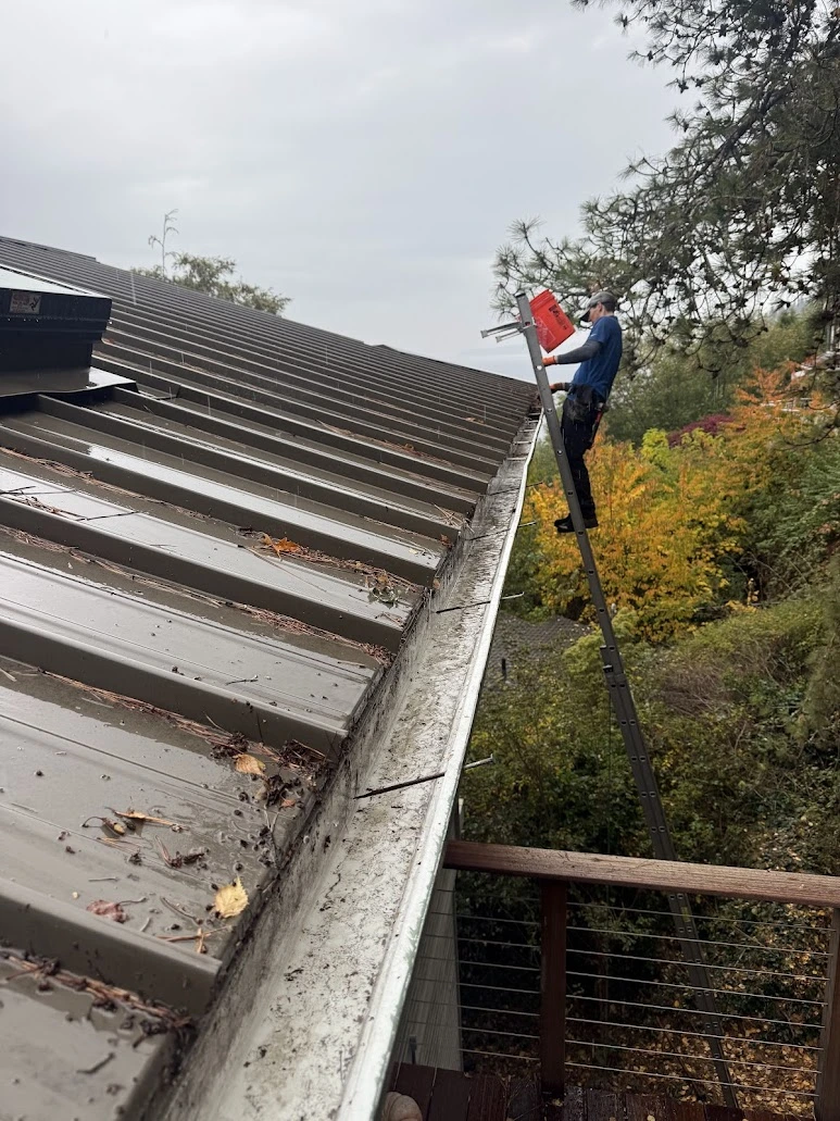 Contractor adjusting exterior work on a ladder